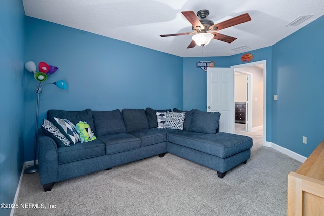 carpeted living room with visible vents, a ceiling fan, and baseboards