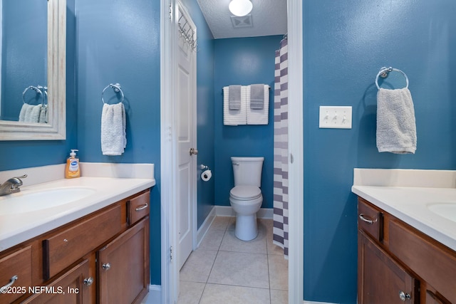 bathroom featuring tile patterned flooring, vanity, toilet, baseboards, and visible vents