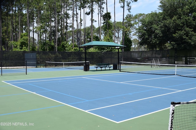 view of tennis court with fence and community basketball court