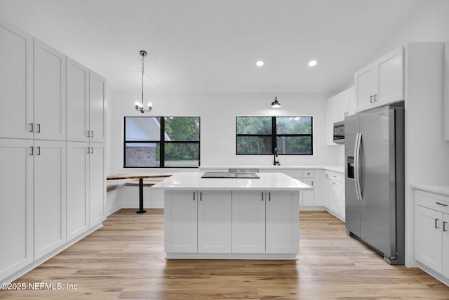 kitchen featuring a center island, recessed lighting, white cabinetry, and appliances with stainless steel finishes
