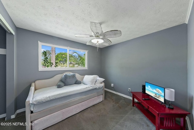 bedroom featuring baseboards, ceiling fan, carpet, and a textured ceiling