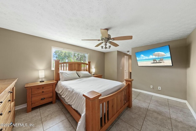 bedroom featuring baseboards, ceiling fan, and light tile patterned floors