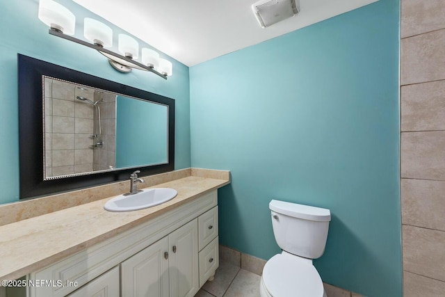 bathroom with visible vents, tile patterned flooring, a tile shower, vanity, and toilet
