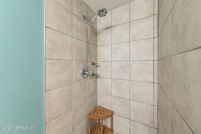 full bath featuring a tile shower