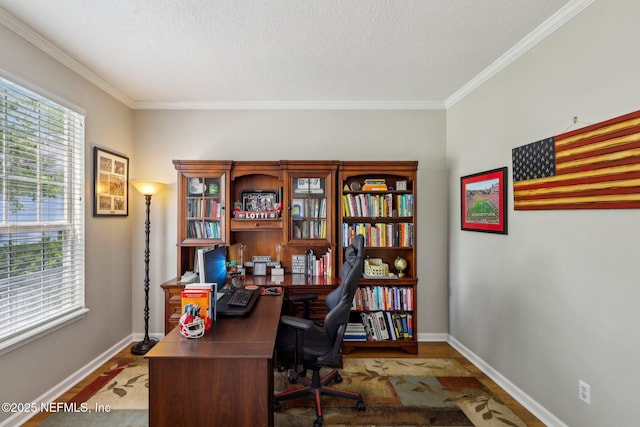 home office with baseboards, plenty of natural light, ornamental molding, and wood finished floors