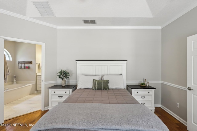 bedroom featuring crown molding, visible vents, and dark wood finished floors