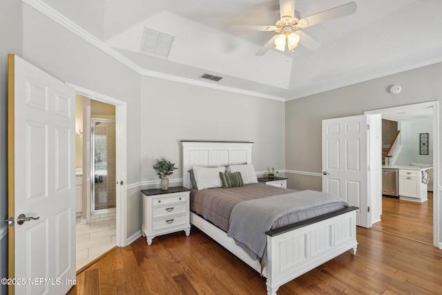 bedroom with dark wood-style flooring, visible vents, and ornamental molding