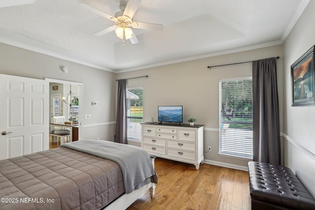 bedroom with light wood-type flooring, crown molding, and ceiling fan