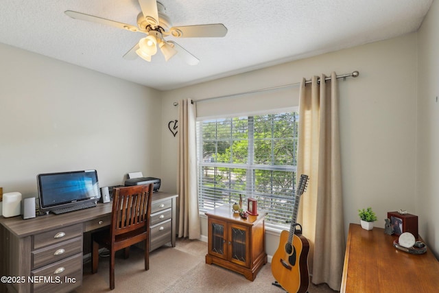 office area featuring light carpet and a ceiling fan