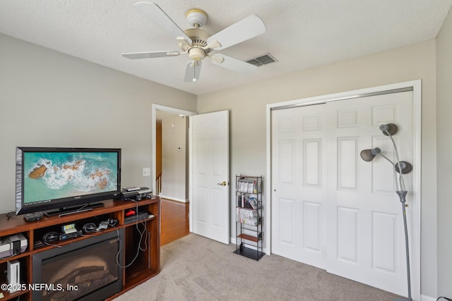 office area featuring ceiling fan, carpet, and visible vents