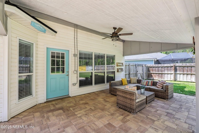 exterior space with an outdoor living space and ceiling fan