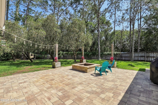 view of patio / terrace with a fenced backyard and a fire pit