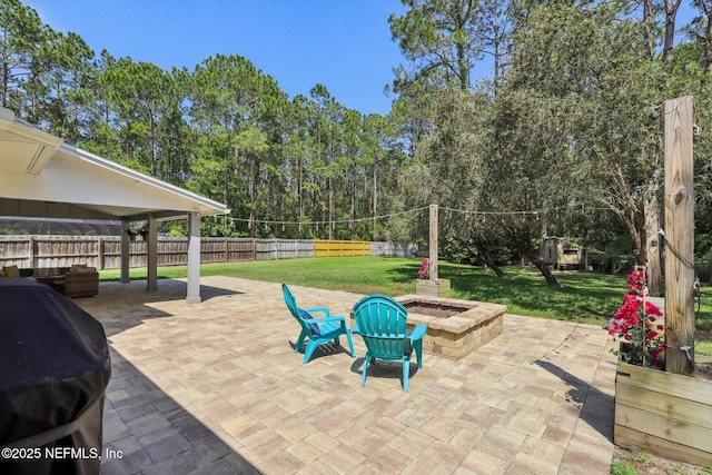 view of patio / terrace featuring a fenced backyard, a grill, and an outdoor fire pit