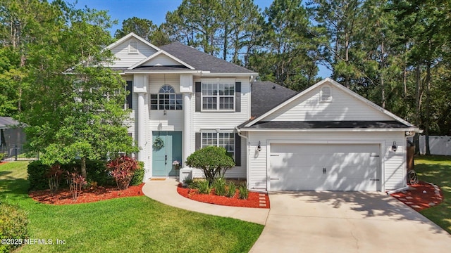 view of front of property with a garage, a front lawn, roof with shingles, and driveway