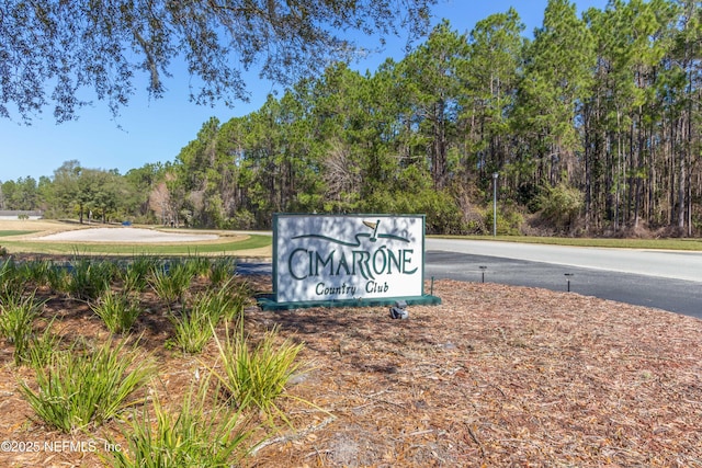 community sign with a forest view