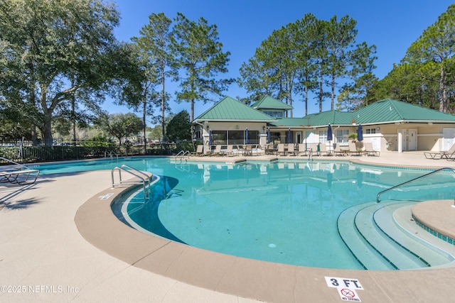 community pool featuring a patio area and fence