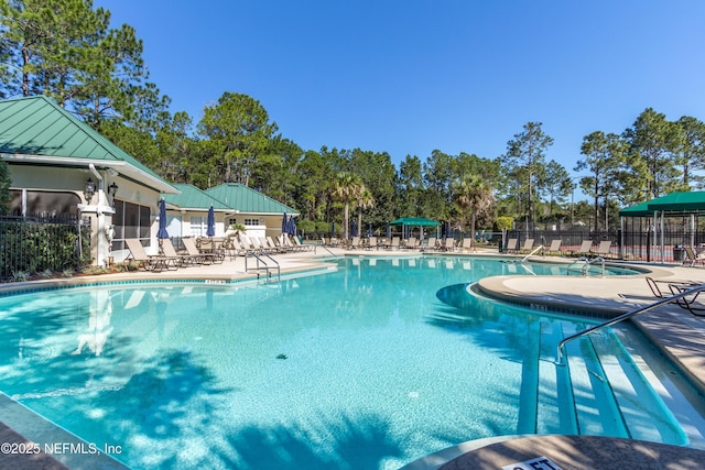 pool featuring a patio area and fence