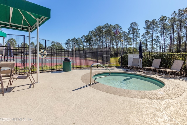 view of swimming pool with a patio, fence, and a pool