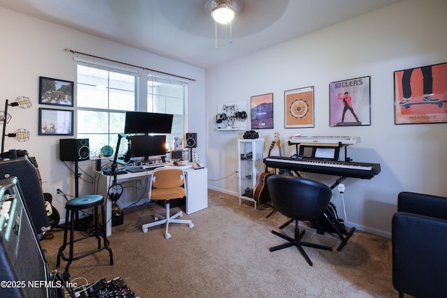 carpeted office space with baseboards and a ceiling fan