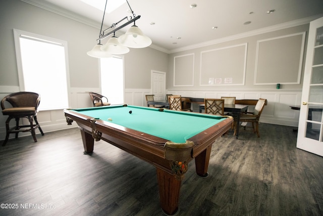 rec room with a decorative wall, pool table, dark wood-style floors, and ornamental molding