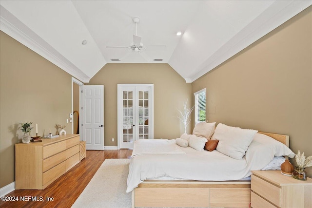 bedroom featuring vaulted ceiling, a ceiling fan, wood finished floors, french doors, and baseboards