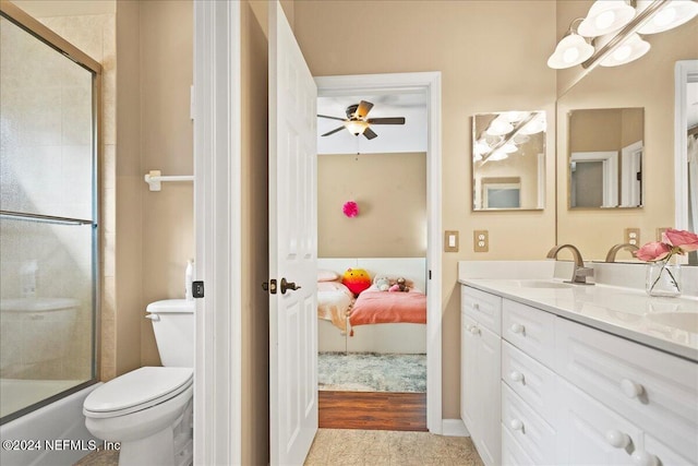 full bathroom featuring vanity, toilet, an enclosed shower, ceiling fan, and ensuite bath
