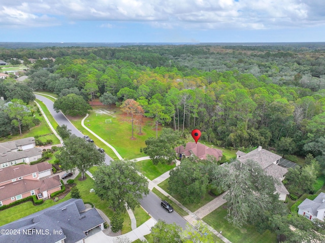 birds eye view of property with a view of trees and a residential view