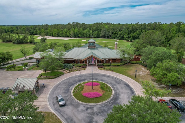 bird's eye view with a wooded view