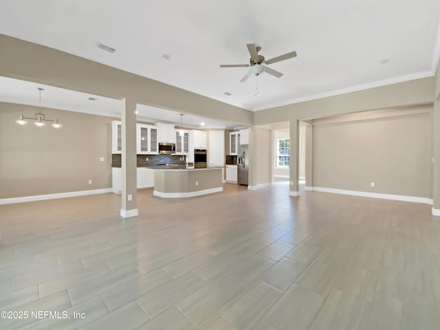 350 Latrobe Ave, Saint Augustine, FL 32095 - unfurnished living room with visible vents, a sink, crown molding, baseboards, and ceiling fan