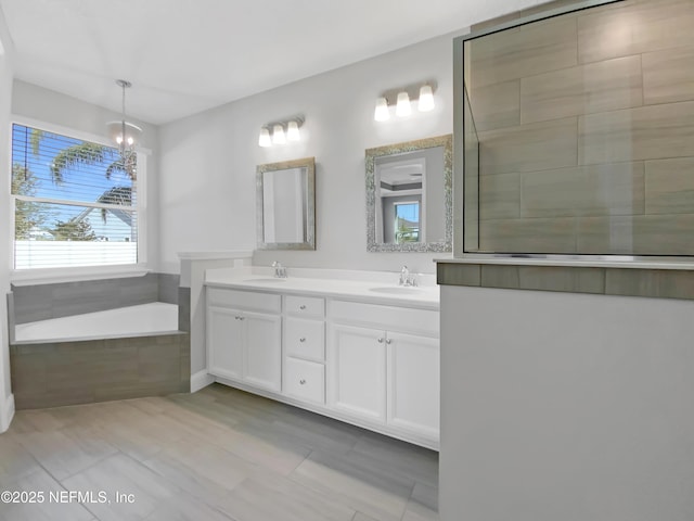 350 Latrobe Ave, Saint Augustine, FL 32095 - full bathroom with a garden tub, a chandelier, a sink, and double vanity