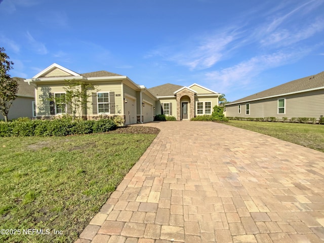 350 Latrobe Ave, Saint Augustine, FL 32095 - view of front of house featuring an attached garage, decorative driveway, and a front yard