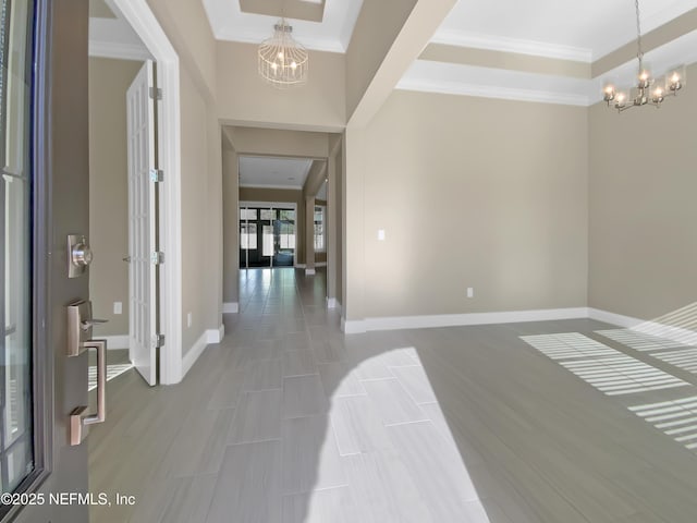 350 Latrobe Ave, Saint Augustine, FL 32095 - entryway with baseboards, an inviting chandelier, ornamental molding, and a raised ceiling