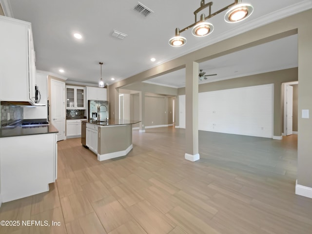 350 Latrobe Ave, Saint Augustine, FL 32095 - kitchen with tasteful backsplash, dark countertops, open floor plan, visible vents, and crown molding