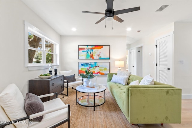 living area featuring light wood-type flooring, ceiling fan, baseboards, visible vents, and recessed lighting