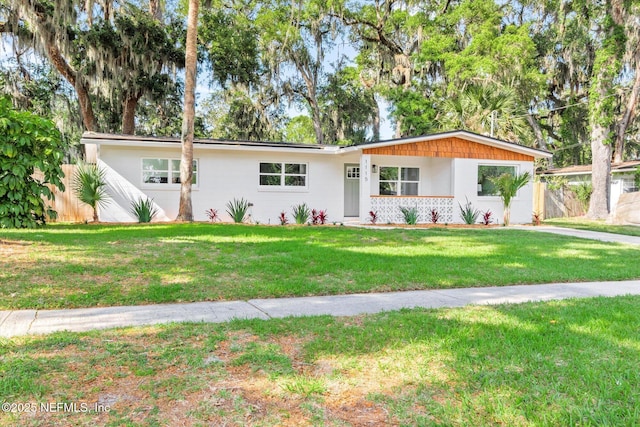 ranch-style house with fence and a front yard