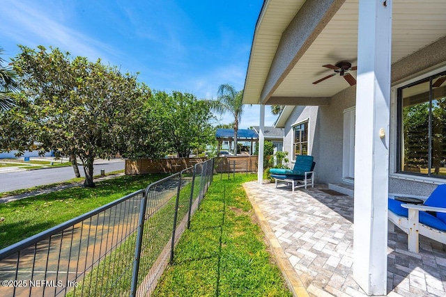 view of yard with ceiling fan and a patio area
