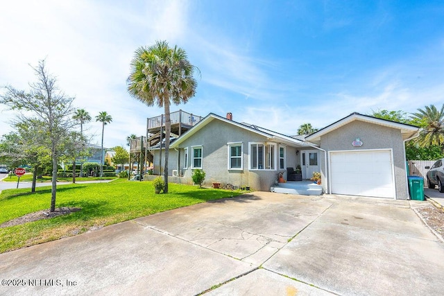 ranch-style home with a garage, concrete driveway, a front lawn, and stucco siding