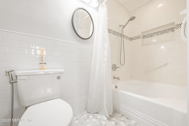 full bathroom with tile walls, shower / bath combo with shower curtain, and toilet