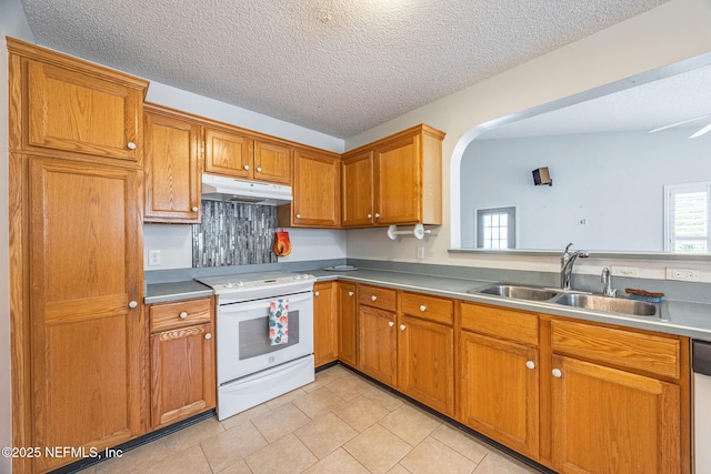 kitchen with electric stove, a sink, under cabinet range hood, brown cabinetry, and light tile patterned flooring