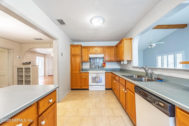 kitchen with white appliances, under cabinet range hood, a sink, ceiling fan, and healthy amount of natural light