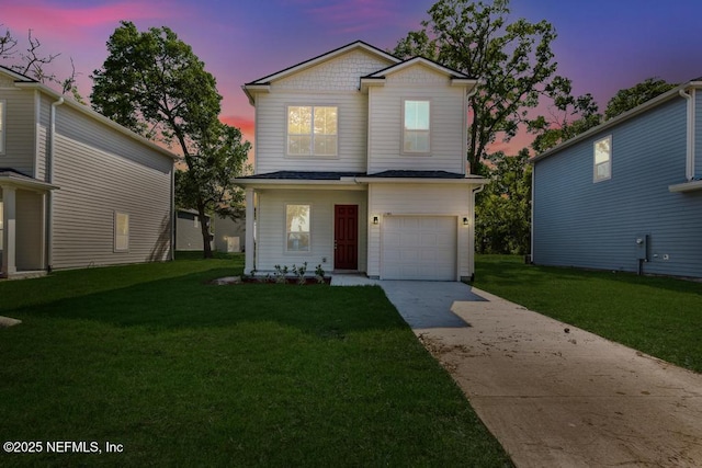 traditional-style home with a lawn, driveway, and a garage