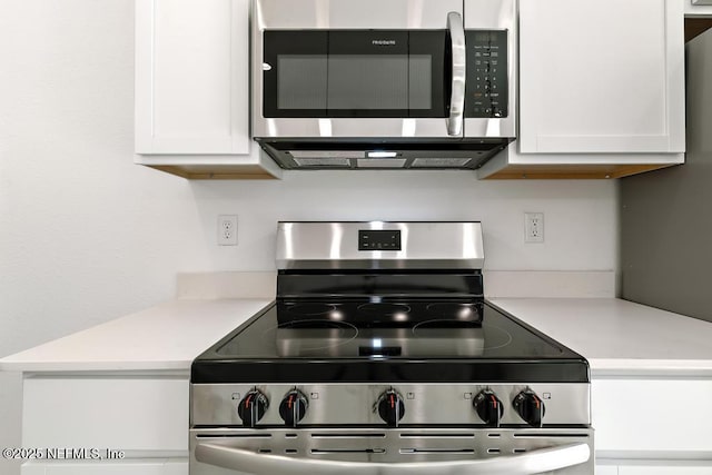 kitchen with light countertops, appliances with stainless steel finishes, and white cabinets