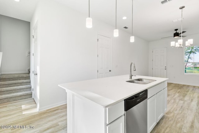 kitchen featuring dishwasher, a sink, light countertops, white cabinets, and light wood-style floors