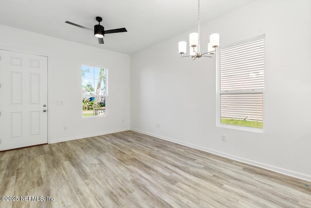 unfurnished room featuring baseboards and light wood finished floors