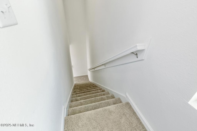 stairs with baseboards and carpet flooring