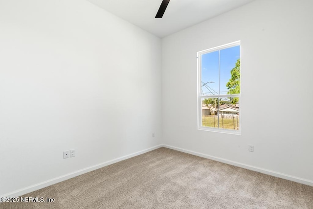 spare room with baseboards, carpet, and ceiling fan
