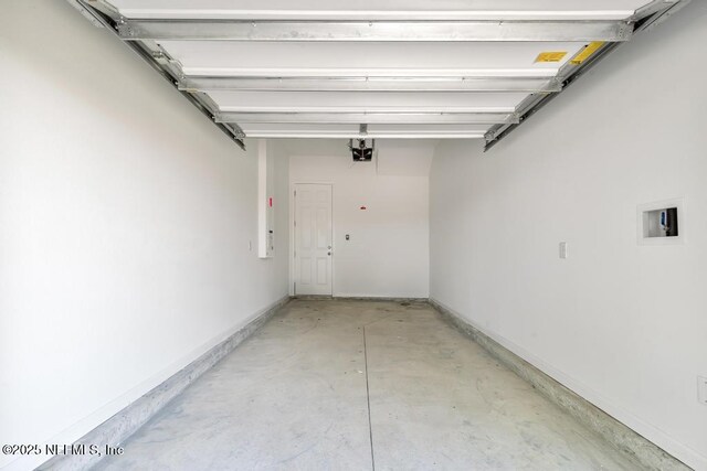 garage featuring baseboards and a garage door opener