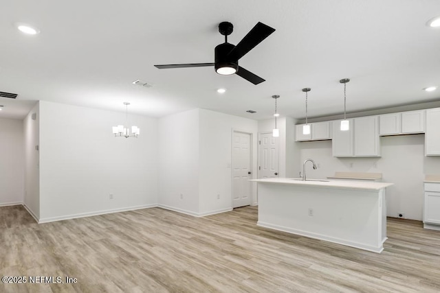 kitchen featuring recessed lighting, light wood-style flooring, and ceiling fan with notable chandelier