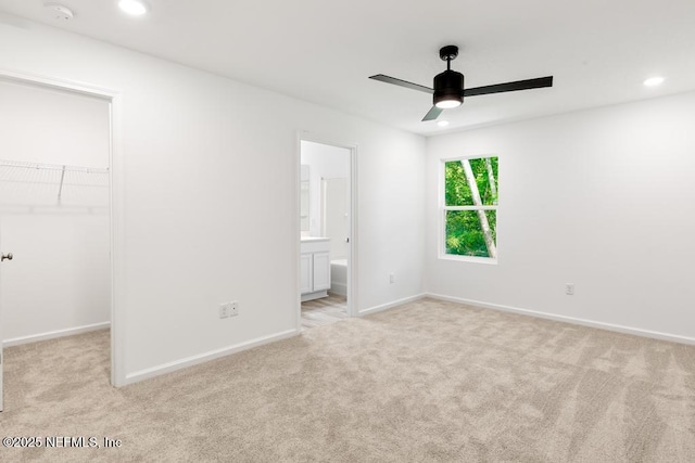 unfurnished bedroom featuring a walk in closet, carpet flooring, and recessed lighting