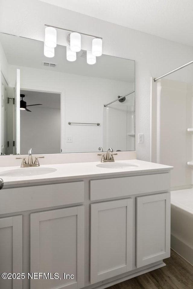 bathroom with bathtub / shower combination, a sink, visible vents, and double vanity